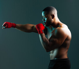 Black man, boxing and sport for fitness on studio background, power workout and fist impact of mma fight. Male person, athlete and exercise, training and strong muscles for wrestling competition