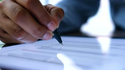 a patient’s hand signing a consent form on a tablet, illustrating the digitization of healthcare documentation
