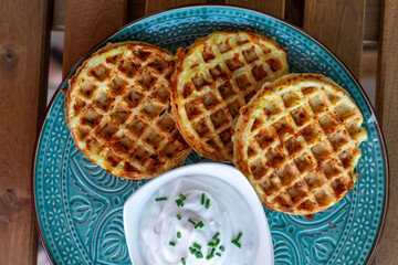 zucchini waffles gofri with sour cream dip on a plate