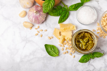 Pesto. Italian basil pesto sauce on a textured wooden background. Ingredient for pesto sauce: fresh...