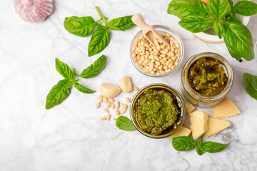 Pesto. Italian basil pesto sauce on a textured wooden background. Ingredient for pesto sauce: fresh...