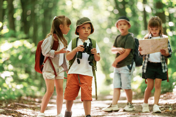 Obraz premium Walking together. Kids in forest at summer daytime