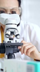 Woman scientist using microscope in laboratory. Microbiology science concept