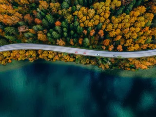 Gardinen Brücken Aerial view of coastline road with autumn fall color woods and blue lakes water in Finland.  © nblxer