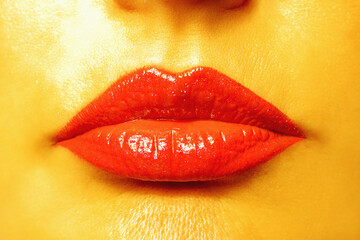 Close up view of beautiful woman lips with golden skin.