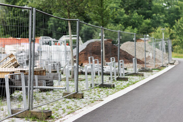 Temporary Metal Fence on Construction Site. Temporary Wire Portable Fence with Concrete Base Blocks.