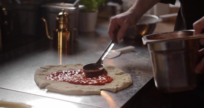 Pizza chef makes a Neapolitan pizza at the cafe