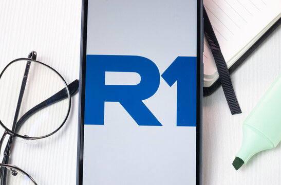 New York, USA - 1 August 2024: R1 RCM Logo on Phone Screen, Company Icon on Display