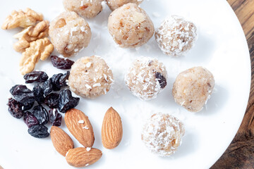 Close up Laddu and almonds and blue raisins. Indian sweets concept. Top view