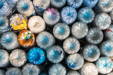 Bottom of plastic water bottles  or plastic bottle bricks or eco-brick background. Pollution, environmental protection. Eco trend to reduce disposable plastics.