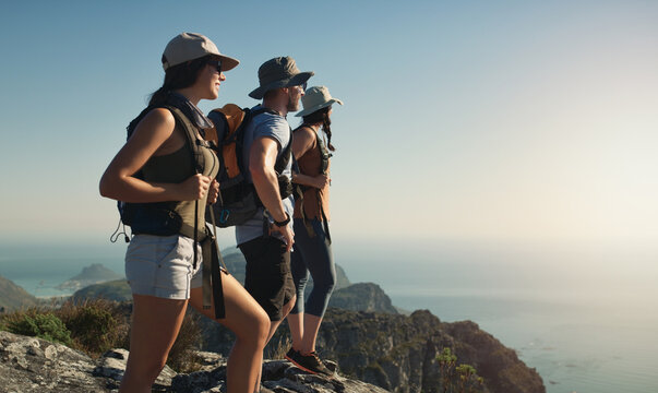 Hiking, mountain and friends on cliff outdoor of fitness travel, adventure view and backpack journey in summer. People, backpacking and trekking together for cardio exercise, rock climbing and health