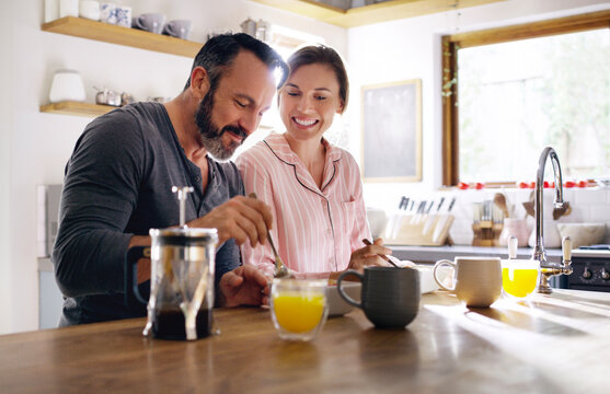 Happy couple, cereal or eating breakfast with love, diet or juice in morning meal in home kitchen. Romantic people, trust or snack in bowl for bonding, support or food in healthy marriage for care