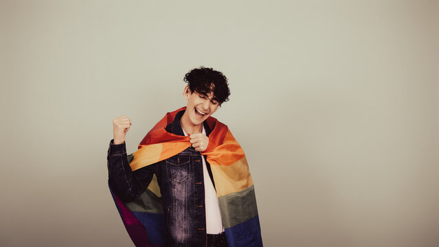 Funny guy posing with a gay flag.