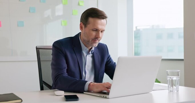 businessman working on laptop computer at modern office