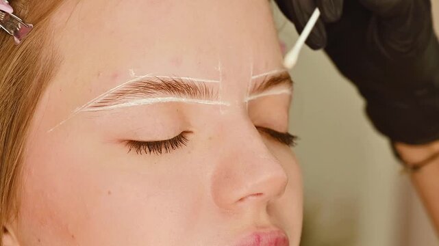Wax correction and coloring of eyebrows of women's eyebrows. Beautiful female eyebrows close-up. Eyebrow care in a beauty studio.