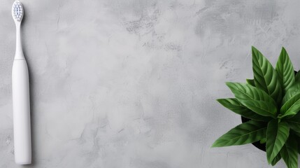 A sleek electric toothbrush sits next to a lush green plant on a minimalist surface