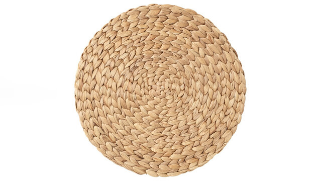 Top view closeup of woven straw coaster on white background.