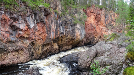 Beautiful red cliffs  coast in summer Kuusamo, August 12, 2020.
