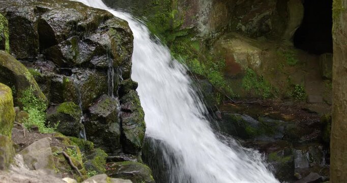 side on mid shot of the Lumsdale waterfalls with rocks and trees in foreground at Lumsdale, Matlock