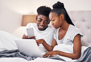 Couple, relax and discussion with technology in bedroom for online menu, research and breakfast idea. Man, woman and conversation with laptop in hotel for mobile room service, order and food delivery