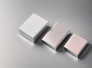 Three boxes with a shiny surface and a pinkish color