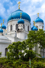 View on domes of the Cathedral of the Dormition of the Blessed Virgin Mary against the blue sky in Biysk, Russia. Cathedral of the Dormition of the Mother of God in Altai Krai