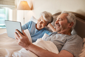 Obraz premium Senior, couple and happy with tablet in bedroom for social media, browsing internet and watch videos. Elderly people, streaming and home with technology for movie, online entertainment and bonding.