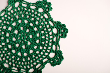 Close-up of a hand-crocheted green doily, perfect for adding a vintage touch to your home decor.
