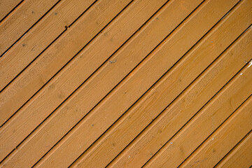 Close up of diagonal wooden planks forming a seamless brown wood texture, ideal for backgrounds,...