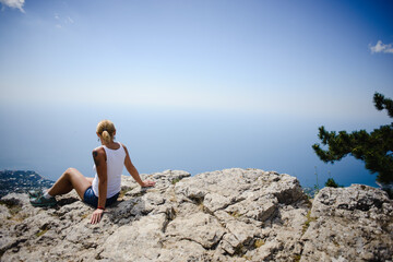 woman sitting on rock