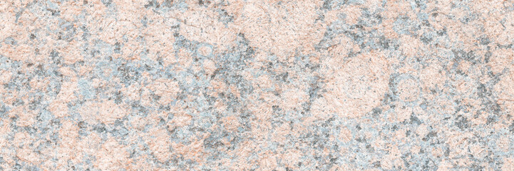 Granite texture. Natural pink granite with a grainy pattern. Stone background. Solid rough surface of rock. Durable construction and decoration material. Close-up.