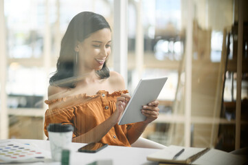 Business woman, tablet and smile for planning, news and research in office with coffee and notebook. Graphic designer, technology and design in workplace for digital agency, website and social media