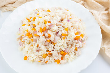 A plate of carrot and meat fried rice
