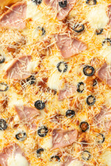the macro composition of pizza for the menu. fresh ingredients are cheese, ham and tomatoes.