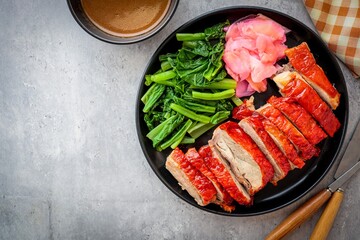 Rosted duck in black ceramic plate on cement background