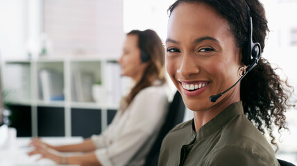 Woman, portrait and happy in call center for customer service, telemarketing and FAQ in office. Female consultant, smile and headset at desk with team, communication and technical support with tech