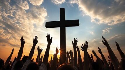 A large group of people with their hands raised in the air, silhouetted against a sunset with a large cross in the background.