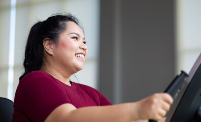 Obraz premium Exercise. beautiful young chubby overweight woman wearing sporty fitness clothes doing exercise indoors at gym fitness sport club, body and health care