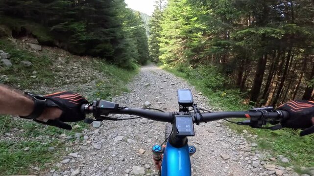 downhill with e mtb on dirt road in Valgerola, Italy