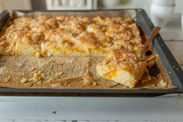 Homemade sheet cake on kitchen counter. Traditional german tangerine almond cake