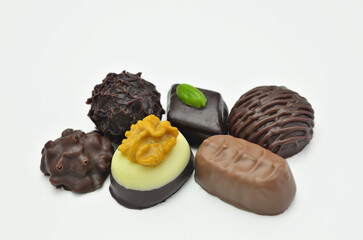 Different kinds of chocolate pralines, close up, isolated on white background