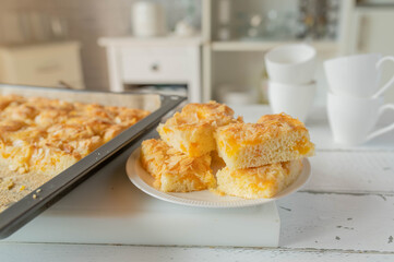 Homemade sheet cake on kitchen counter. Traditional german tangerine almond cake
