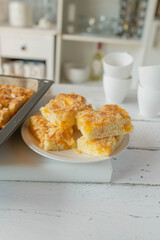 Homemade sheet cake on kitchen counter. Traditional german tangerine almond cake