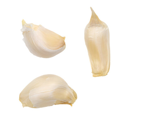 Three cloves of garlic on white background