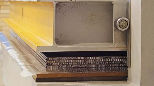 Close-up view of an industrial press, which is used to exert pressure and compress metal sheets and plates. Close up. Slow motion