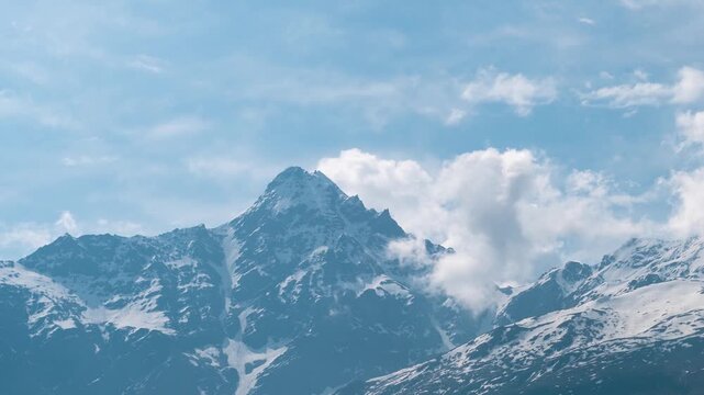 4k timelapse of soft white clouds moving over snow mountains at Keylong in lahaul, Himachal Pradesh, India. Monsoon clouds in mountains. Nature landscape. Epic Himalayas time lapse.