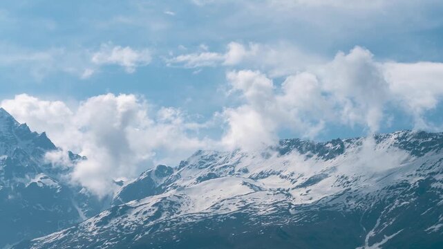 4K timelapse of soft white clouds moving over snow mountains at lahaul, Himachal Pradesh, India. Monsoon clouds in mountains. Nature landscape. Epic Himalayas time lapse.