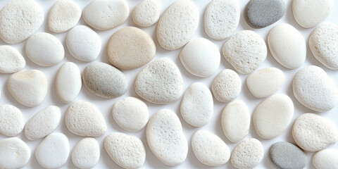 a collection of smooth, white pebbles arranged closely together. They vary in size and shape, some more oval and others more rounded, with polished surfaces giving them a clean, uniform appearance