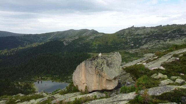 Aerial view of rocky mountains peaks and lake from above. Scenic Lake surrounded by Mountains and trees. Ergaki national park. Beautiful Landscape. 