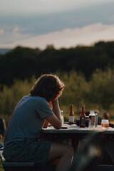 man sitting on a bench during sunset hour 